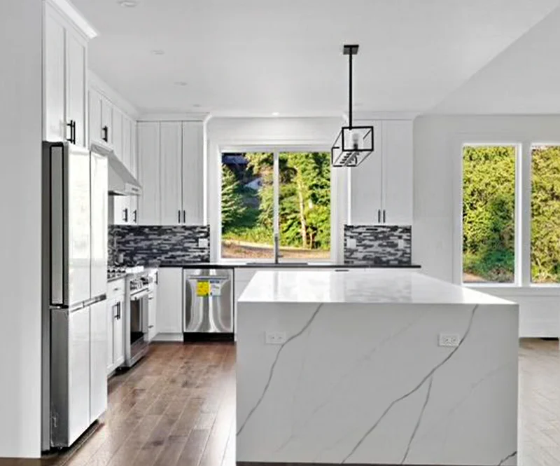Newly Installed White Kitchen With Waterfall Countertop 800x665