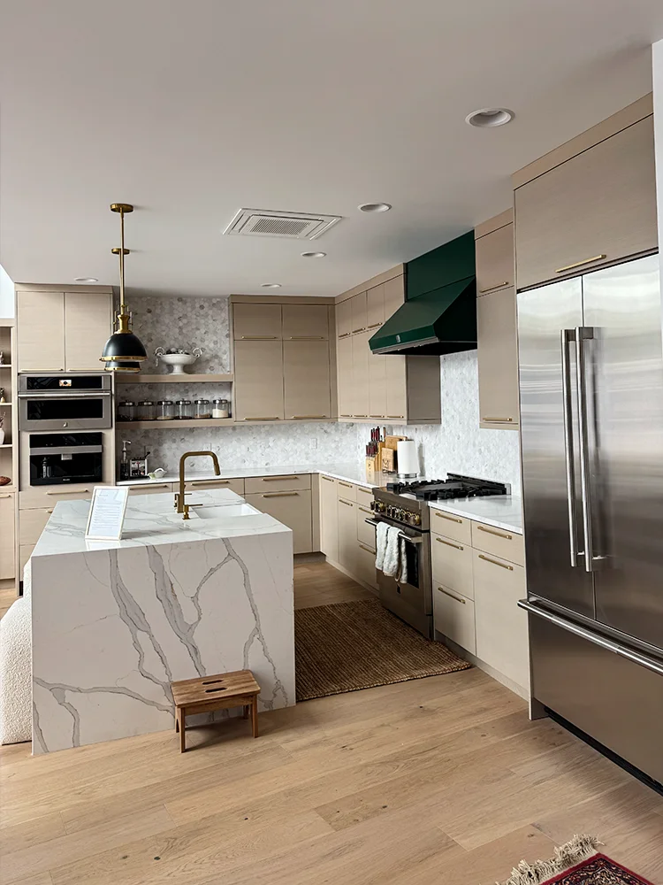 Tan European Style Cabinets And Marble Waterfall Island 1
